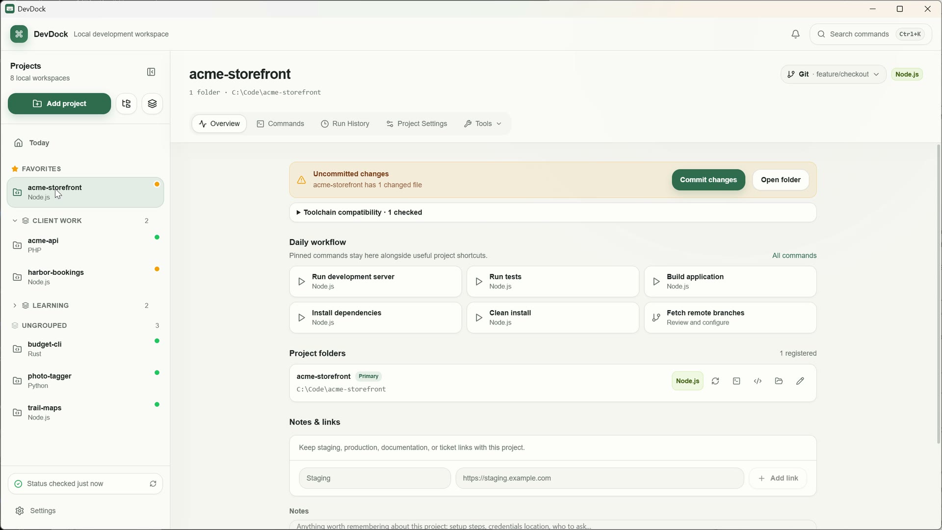 DevDock on Windows with projects sorted into Favorites, Client work, Learning and Ungrouped, and acme-storefront open on its feature/checkout branch with uncommitted changes